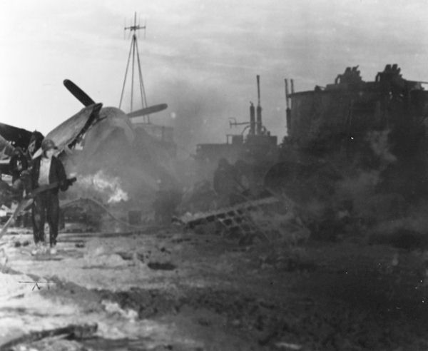 Destroyed planes and other wreckage litter the deck of Enterprise CV-6, 20 March 1945.